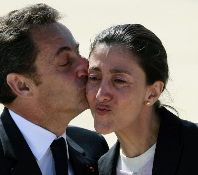 Former hostage Ingrid Betancourt is kissed by French President Nicolas Sarkozy, left, as she arrives at Villacoublay air base, outside Paris, Friday July 4, 2008. The dual French-Colombian citizen was freed Wednesday in a daring military rescue operation that also liberated three U.S. military contractors and 11 others held captive by Colombian rebels. (AP Photo/Michel Spingler) 