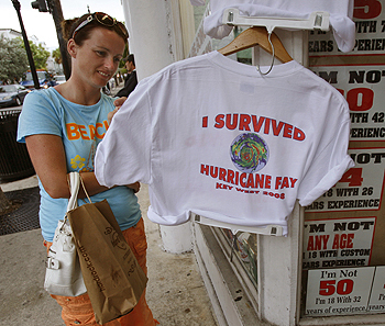Deirdre Collins of Limerick, Ireland checks out a T-shirt at a shop on Duval Street Sunday, Aug. 17, 2008 in Key West, Fla. Tropical Storm Fay, which forecasters said could strengthen to a hurricane, could start pelting parts of the Keys and South Florida late Monday or early Tuesday as a strong tropical storm or minimal hurricane. Florida Keys officials closed schools, opened shelters and urged visitors to leave as Tropical Storm Fay threatened to strengthen into a hurricane Sunday, but residents and tourists seemed in no hurry to evacuate. AP 