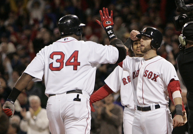 Boston Red Sox designated hitter David Ortiz (34) is congratulated by teammate Dustin Pedroia after his three run home run in the seventh inning in Game 5 of the American League baseball championship series against the Tampa Bay Rays in Boston, Thursday, Oct. 16, 2008. (AP Photo/Winslow Townson) 