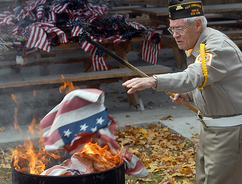 VFW Post 2475 past Commander Gene Slavin burns American flags on Tuesday afternoon Nov. 11, 2008 at the VFW Post 2475 in Glens Falls N.Y. Prior to burning the flags, VFW member held a ceremony to mark the tradition. AP 