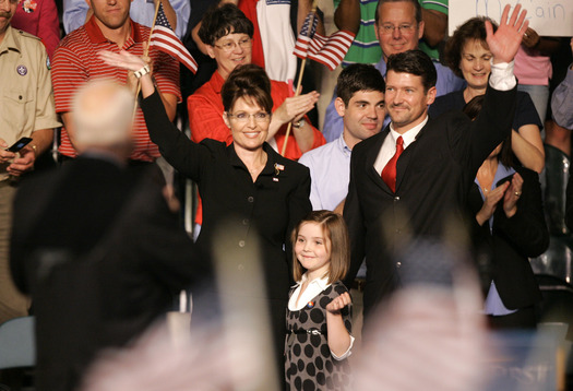 Republican Alaska Gov. Sarah Palin and her husband Todd waves as she was introduced as Vie Presidential running mate for Republican Presidential candidate, Sen. John McCain, R-Ariz., left, Friday, Aug. 29, 2008 at Ervin J. Nutter Center in Dayton, Ohio. Center is their daughter Piper. (AP Photo/Kiichiro Sato) 