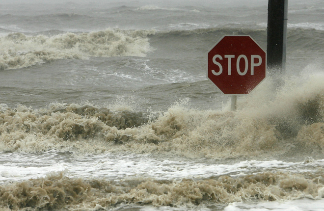 Waves crash against a stop sign on Beach Boulevard in Bay St. Louis, Miss. on Monday, Sept. 1, 2008, as Hurricane Gustav hits the Gulf Coast. (AP Photo/William Colgin, Sun Herald) 