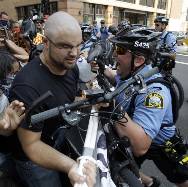St. Paul police officers push back a group of protesters who were using a large sign during an anti-war protest at the Republican National Convention in St. Paul, Minn., Monday, Sept. 1, 2008. (AP Photo/Matt Rourke) 